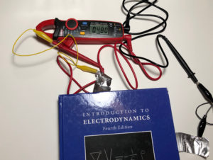 Electrodynamics book being used as a capacitor